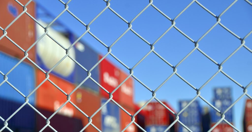 Container behind a chain-link fence
